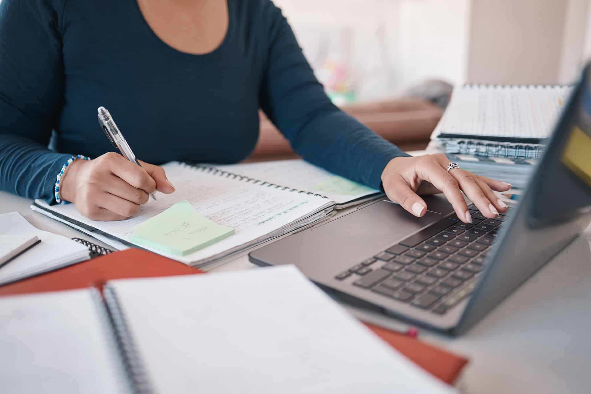 notebook laptop and writing hands of black woman o ZDYYSGP